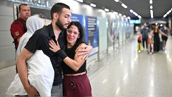 A Brazilian immigrant, deported from the US, is welcomed by a relative at the Confins airport in Brazil. Reuters
