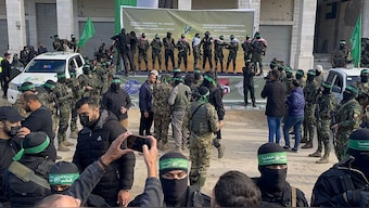 Hamas fighters gahter at a square before handing over four Israeli hostages to the Red Cross in Gaza City on January 25, 2025. AFP
