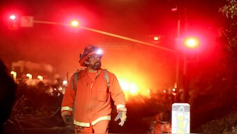 A California Department of Corrections hand crew works containment lines ahead of the Palisades Fire in Santa Monica, California, on Tuesday.  AP