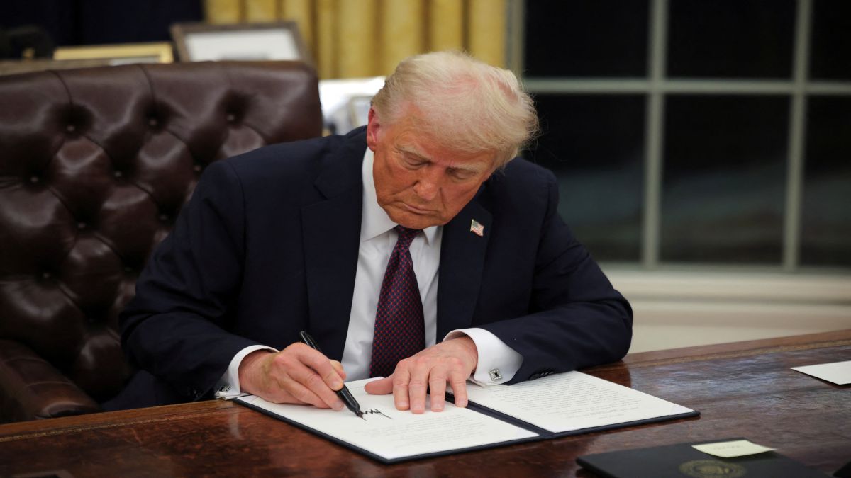 US President Donald Trump signs documents as he issues executive orders. Reuters File US President Donald Trump signs documents as he issues executive orders. Reuters File