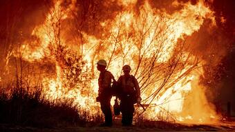 Fire crews battle the Kenneth Fire in the West Hills section of Los Angeles, Thursday, on January 9. AP