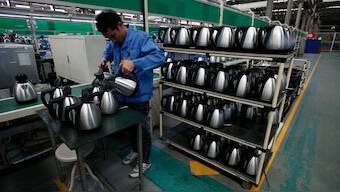 A Galanz employee tests electric kettles at a production line in a factory in Zhongshan, southern Chinese province of Guangdong November 12, 2011. Galanz is a Chinese company and one of the largest producer of microwave ovens in the world. File Image/Reuters