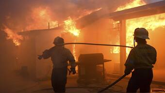 Firefighters battle the Eaton Fire as it engulfs structures in California. AP