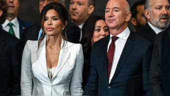 Amazon founder Jeff Bezos' fiancee Lauren Sanchez opted for an ensemble featuring a white lace corset paired with a tailored, single-breasted white blazer adorned with crossover lapels by Alexander McQueen. AFP