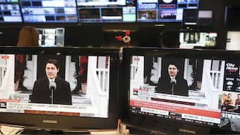 Canada Prime Minister Justin Trudeau is seen on screens in a control room at City News in Toronto as he holds a new conference in Ottawa announcing his resignation. AP