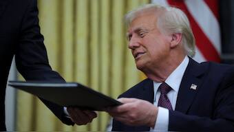 US President Donald Trump reacts on the day he signs documents as he issues executive orders and pardons for January 6 defendants in the Oval Office at the White House on Inauguration Day in Washington. Reuters