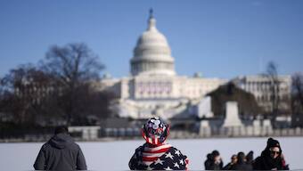 People stand in front of the US Capitol on the day it was announced US President-elect Donald Trump's inauguration is being moved indoors due to dangerously cold temperatures expected on Monday, in Washington. Reuters