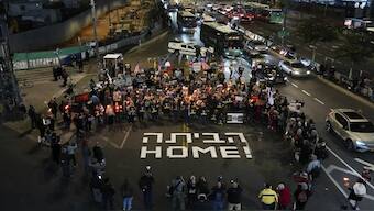 Demonstrators hold torches during a protest calling for the release of the hostages held in the Gaza Strip by Hamas in Tel Aviv, Israel. As per a draft, the first phase of the ceasefire, if agreed upon, will see the release of 33 hostages held by the militant group. AP