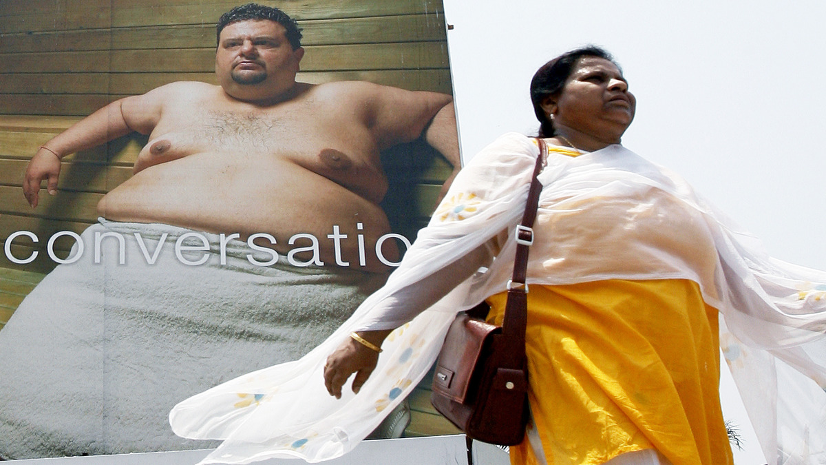 A woman walks past a billboard in Mumbai, April 19, 2007. Reuters/Representational Image A woman walks past a billboard in Mumbai, April 19, 2007. Reuters/Representational Image