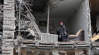 A resident stands in her flat in an apartment building hit by a Russian missile strike, amid Russia's attack on Ukraine, in Zaporizhzhia, Ukraine. File image/ Reuters