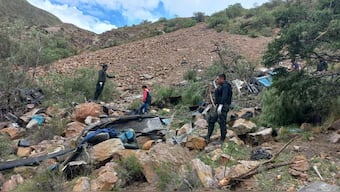 This handout picture released by the Bolivian Police shows police officers searching for survivors in the wreckage of a passenger bus that fell into an abyss near the town of Yocalla, between Potosi and Oruro, Bolivia, on February 17, 2025. AFP