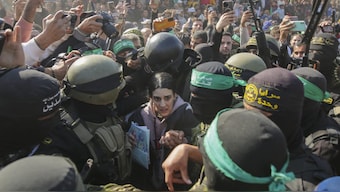Israeli captive Arbel Yehoud, 29, who has been held hostage by Hamas in Gaza since October 7, 2023, is escorted by Hamas and Islamic Jihad fighters as she is handed over to the Red Cross in Khan Younis, southern Gaza Strip, Thursday Jan. 30, 2025.(AP Photo/Jehad Alshrafi)