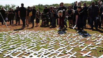 People place white crosses representing farmers killed in the country at a ceremony at the Vorrtrekker Monument in Pretoria, South Africa, October 30, 2017. AP