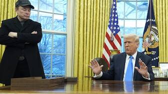 President Donald Trump speaks with reporters as Elon Musk listens in the Oval Office at the White House, in Washington. AP