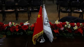 The flags of the China and the Islamic Emirate of Afghanistan are displayed during a news conference. Reuters