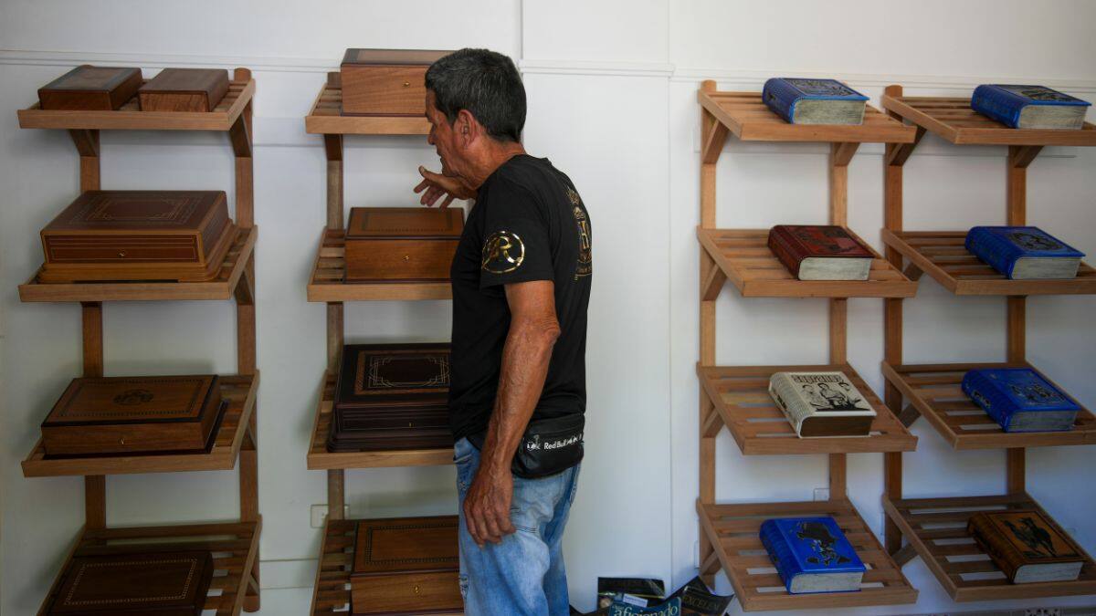 A worker at the Humidors Habana Art Creation Workshop shows cigar humidifiers in Havana, Cuba, Wednesday, February 19, 2025. File Image/AP