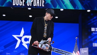 Elon Musk, the head of the Department of Government Efficiency (DOGE), holds a chainsaw as he speaks at the annual Conservative Political Action Conference (CPAC) at the Gaylord National Resort & Convention Center at National Harbor in Oxon Hill, Maryland. AFP