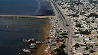 Fishers' boats are docked along the beach next to a new built highway in Gwadar, Pakistan, Tuesday, Jan. 14, 2025. (Photo: AP)