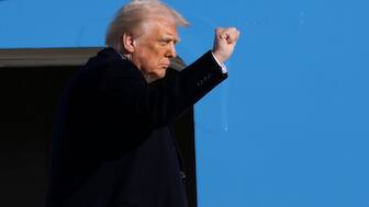 US President Donald Trump gestures as he boards Air Force One at Joint Base Andrews, Maryland, USA. (Photo: AP)