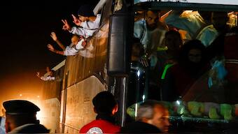 Freed Palestinian prisoners gesture out of the windows as they arrive in a bus after being released from an Israeli jail as part of a ceasefire and a hostages-prisoners swap deal between Hamas and Israel, in Khan Younis in the southern Gaza Strip, on Thursday. Reuters
