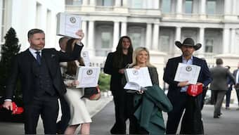 Political commentator Rogan O'Handley, a.k.a. DC Draino, and other unidentified people carrying binders bearing the seal of the U.S. Justice Department reading "The Epstein Files: Phase 1" walk out of the West Wing of the White House on Feb. 27, 2025. AFP