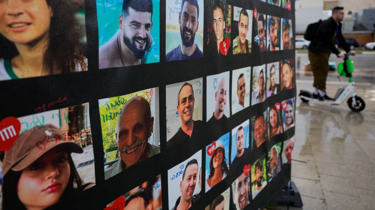A man rides past a banner with pictures of hostages, on the day the bodies of deceased Israeli hostages are handed over under the terms of a ceasefire. Reuters A man rides past a banner with pictures of hostages, on the day the bodies of deceased Israeli hostages are handed over under the terms of a ceasefire. Reuters