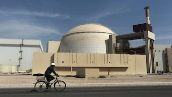  A worker rides a bicycle in front of the reactor building of the Bushehr nuclear power plant, just outside the southern city of Bushehr, Iran, on October 26, 2010. AP File