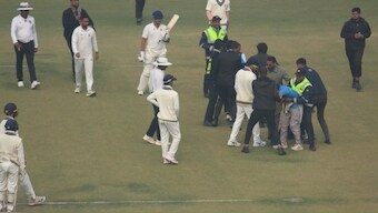 Fans invaded the pitch to touch Virat Kohli's feet during Delhi's ranji Trophy match against Railways. Image: Screengrab 