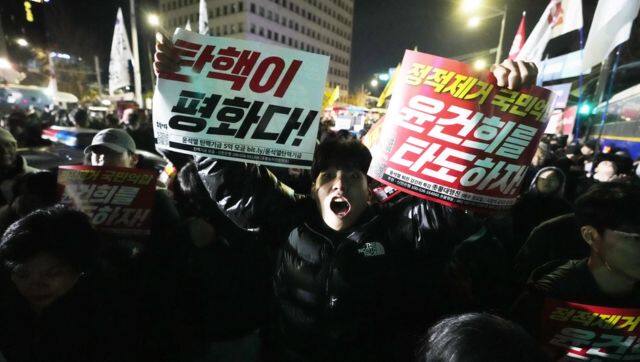 A man shouts to demand South Korean President Yoon to step down in front of the National Assembly in Seoul. File image/AP 