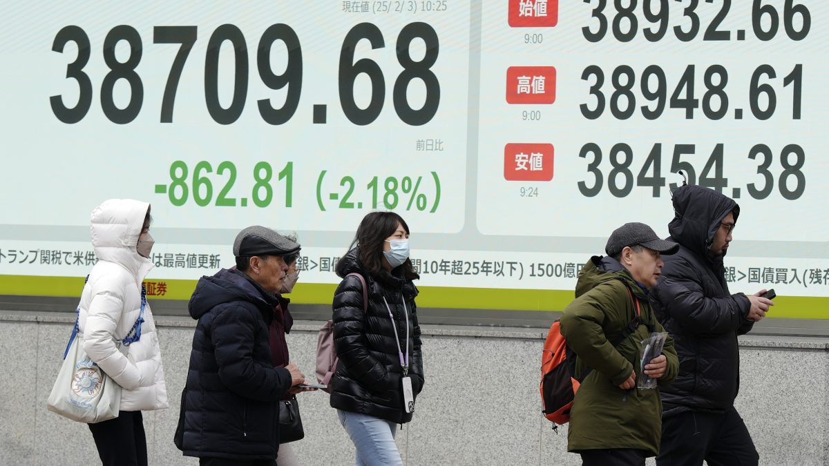People walk in front of an electronic stock board showing Japan's Nikkei index at a securities firm in Tokyo. AP People walk in front of an electronic stock board showing Japan's Nikkei index at a securities firm in Tokyo. AP