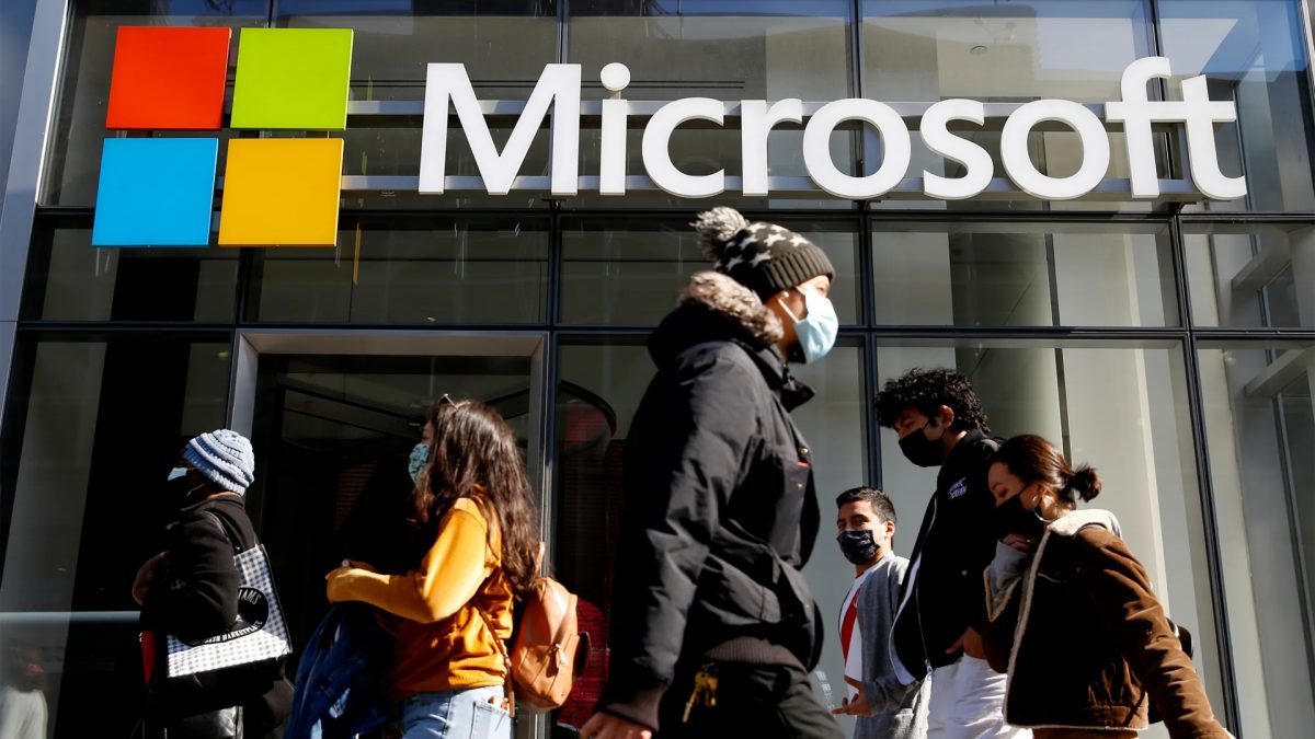People walk past a building with the Microsoft logo. (Representative Image, Credit: Reuters) People walk past a building with the Microsoft logo. (Representative Image, Credit: Reuters)