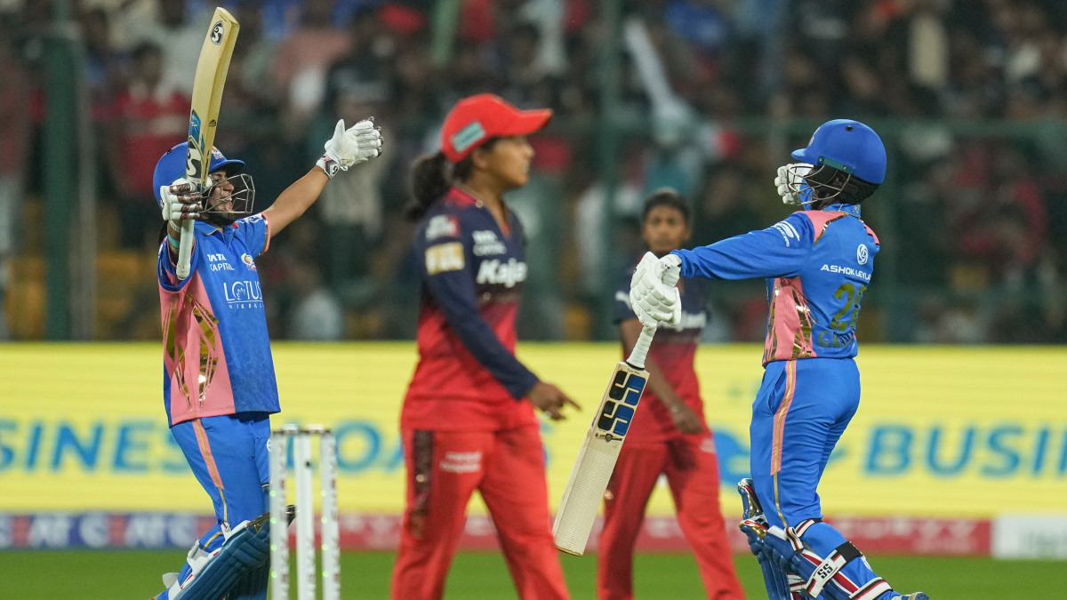 Mumbai Indians' Amanjot Kaur and G Kamalini celebrate after the latter struck the winning boundary, sealing a four-wicket victory over Royal Challengers Bengaluru with one ball to spare. PTI Mumbai Indians' Amanjot Kaur and G Kamalini celebrate after the latter struck the winning boundary, sealing a four-wicket victory over Royal Challengers Bengaluru with one ball to spare. PTI