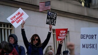 Demonstrators hold signs as they rally outside the US Treasury Department after it was reported billionaire Elon Musk, who is heading US President Donald Trump's drive to shrink the federal government, has gained access to Treasury's federal payments system that sends out more than $6 trillion per year in payments on behalf of federal agencies and contains the personal information of millions of Americans, in Washington, US, February 4, 2025. File Image/Reuters