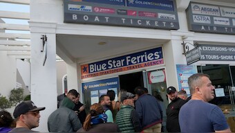People wait to buy boat and air tickets as Greek authorities are taking emergency measures in response to intense seismic activity on the popular Aegean Sea holiday island of Santorini, southern Greece, Monday, Feb. 3, 2025. Image- AP