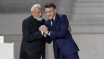 French President Emmanuel Macron, right, shakes hands with Prime Minister Narendra Modi after addressing the audience in a closing speech at the Grand Palais during the Artificial Intelligence Action Summit in Paris, on February 11, 2025 | Photo- AP

