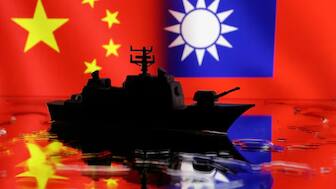 A Navy miniature is seen in front of displayed Chinese and Taiwanese flags in this illustration taken, April 11, 2023. File Image- Reuters