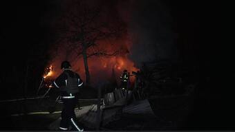 Firefighters working to extinguish a fire at the site following a massive drone attack, in Kyiv, amid the Russian invasion of Ukraine. Image- AFP