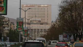 Vehicles drive as the Syrian central bank is seen in the background in Damascus, Syria February 12, 2025. - Reuters