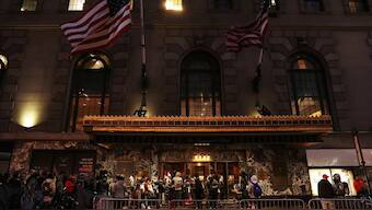 People stand outside the Roosevelt Hotel, which has acted as a makeshift shelter for arriving migrants in the Midtown section of New York City, US, November 28, 2023. File Image/Reuters
