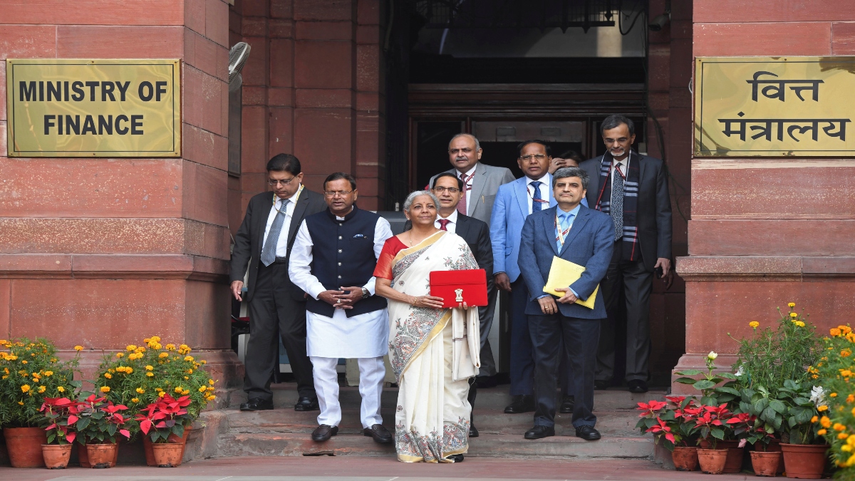 Finance Minister Nirmala Sitharaman, carrying a red pouch containing budget documents, poses for a photograph with colleagues as she arrives to present the budget in the Parliament in New Delhi, on Saturday. AP Finance Minister Nirmala Sitharaman, carrying a red pouch containing budget documents, poses for a photograph with colleagues as she arrives to present the budget in the Parliament in New Delhi, on Saturday. AP