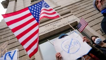People hold placards outside the USAID building, after billionaire Elon Musk, who is heading US President Donald Trump's drive to shrink the federal government, said work is underway to shut down the US foreign aid agency USAID, in Washington, US, February 3, 2025. File Image/Reuters