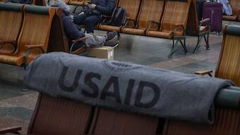 Passengers rest in the waiting room as an one of the blankets donated by the United States Agency for International Development is seen, during a power outage after critical civil infrastructure was hit by a Russian missile attacks in Ukraine at central railway station in Kyiv, Ukraine, November 25, 2022. File Image/Reuters