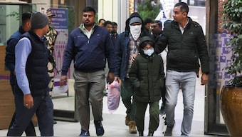 Security personnel escort Indian immigrants deported from the US. Reuters
