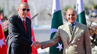 Turkey's President Recep Tayyip Erdogan (L) shaking hands with Pakistan's Prime Minister Shehbaz Sharif. AFP