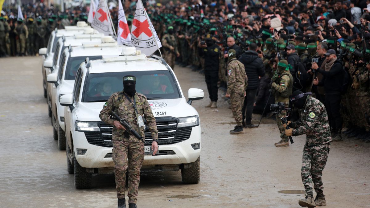 A Palestinian Hamas fighter precedes International Red Cross (ICRC) vehicles as they arrive in Nuseirat in the central Gaza Strip to receive three Israeli hostages as part of the seventh hostage-prisoner swap on February 22, 2025. AFP A Palestinian Hamas fighter precedes International Red Cross (ICRC) vehicles as they arrive in Nuseirat in the central Gaza Strip to receive three Israeli hostages as part of the seventh hostage-prisoner swap on February 22, 2025. AFP