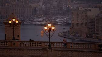 A man looks out over the Grand Harbour at dawn in Valletta, Malta, May 15, 2024. File Photo/Reuters