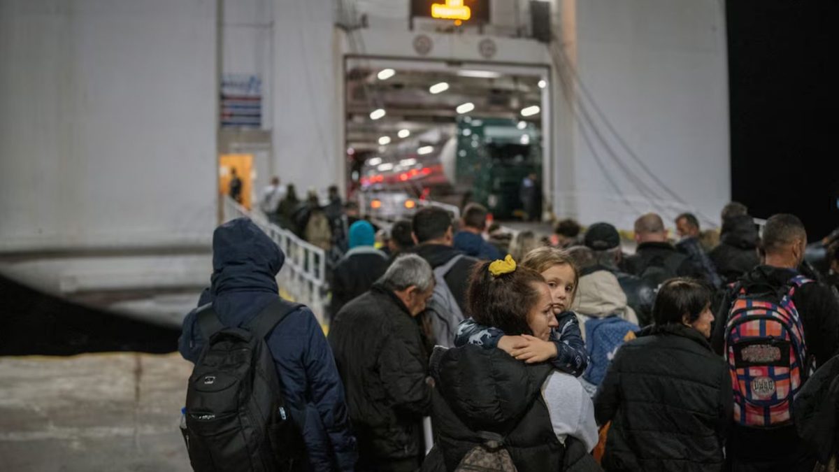 A woman carries her daughter as people board a ferry to Piraeus, following an increase in seismic activity on the island of Santorini, Greece. Image Source: Reuters A woman carries her daughter as people board a ferry to Piraeus, following an increase in seismic activity on the island of Santorini, Greece. Image Source: Reuters