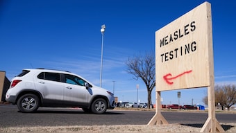 A vehicle drives past a sign outside of a hospital offering measles testing in Seminole, Texas. AP/File Photo
