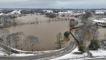 A high-rising Barren River flows through Bowling Green, Ky., after heavy rainfall beginning early Saturday morning brought nearly five inches of rain and snowfall to Warren County. AP