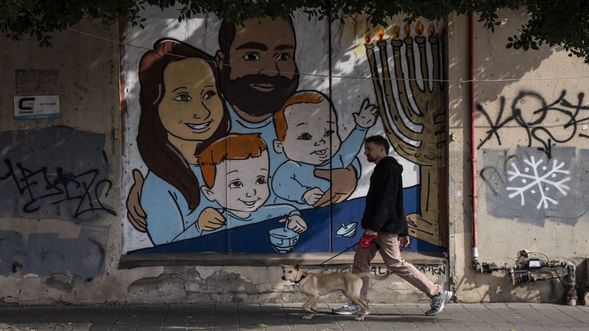 A man walks his dog past graffiti of Shiri and Yarden Bibas and their sons, Ariel, left, and Kfir (right), who were taken captive by Hamas, in Tel Aviv, Israel, While Yarden Bibas was freed from captivity earlier this month, the bodies of Shiri, Ariel and Kfir will be handed over today. AP A man walks his dog past graffiti of Shiri and Yarden Bibas and their sons, Ariel, left, and Kfir (right), who were taken captive by Hamas, in Tel Aviv, Israel, While Yarden Bibas was freed from captivity earlier this month, the bodies of Shiri, Ariel and Kfir will be handed over today. AP